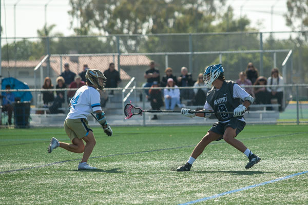 Newport Harbor’s Parker Atkins (#8) holding strong defense against an offensive drive by Corona del Mar’s Owen Majit (#4).