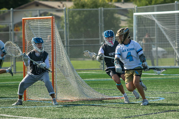 Newport Harbor’s Jayden Hernandez (#0) and Wesley Orange (#6) defending their goal against Corona del Mar’s Owen Majit (#4).
