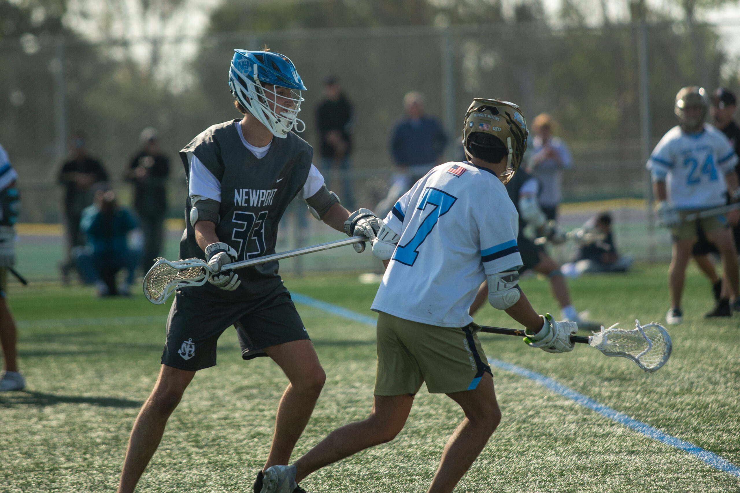 Newport Harbor’s James Beaver (#33) defending against Corona del Mar’s Auggy Luong (#7).